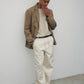 Model wearing bone elias top with cream pants, black oxfords, and khaki blazer