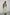 Model wearing bone elias top with cream pants, black oxfords, and khaki blazer