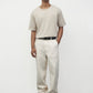 Model wearing bone elias top with cream pants and black oxfords, front view