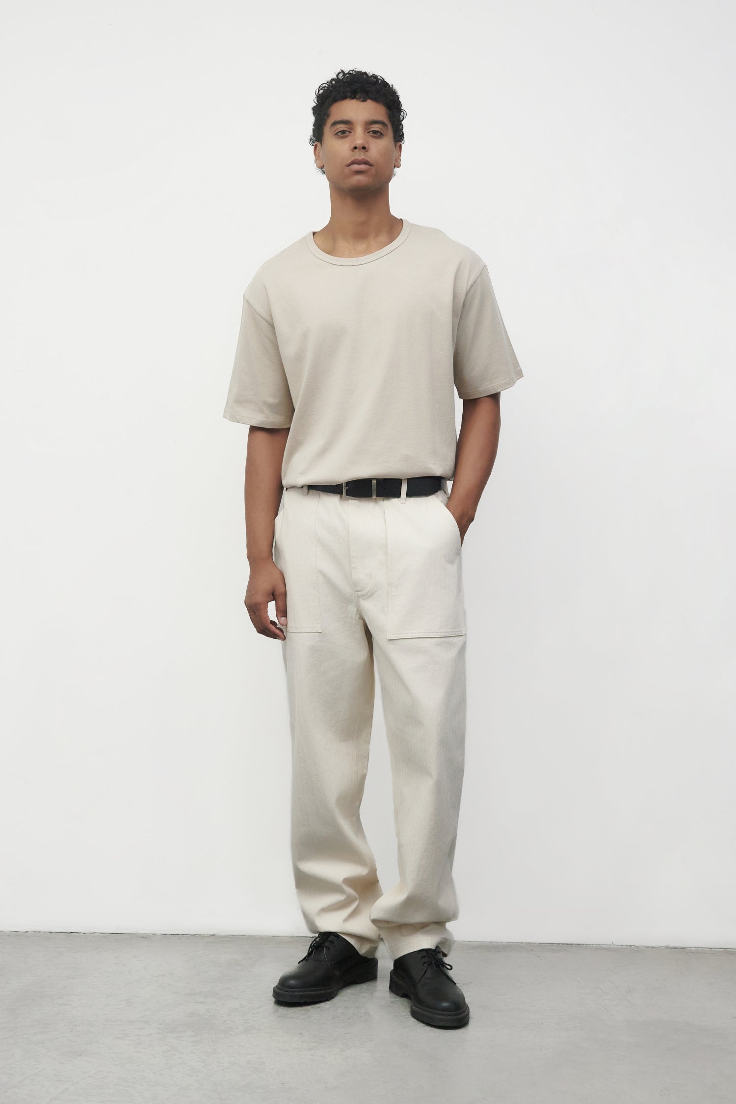 Model wearing bone elias top with cream pants and black oxfords, front view