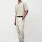 Model wearing bone elias top with cream pants and black oxfords, side view