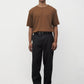Model wearing brown elias top with black trousers and black boots