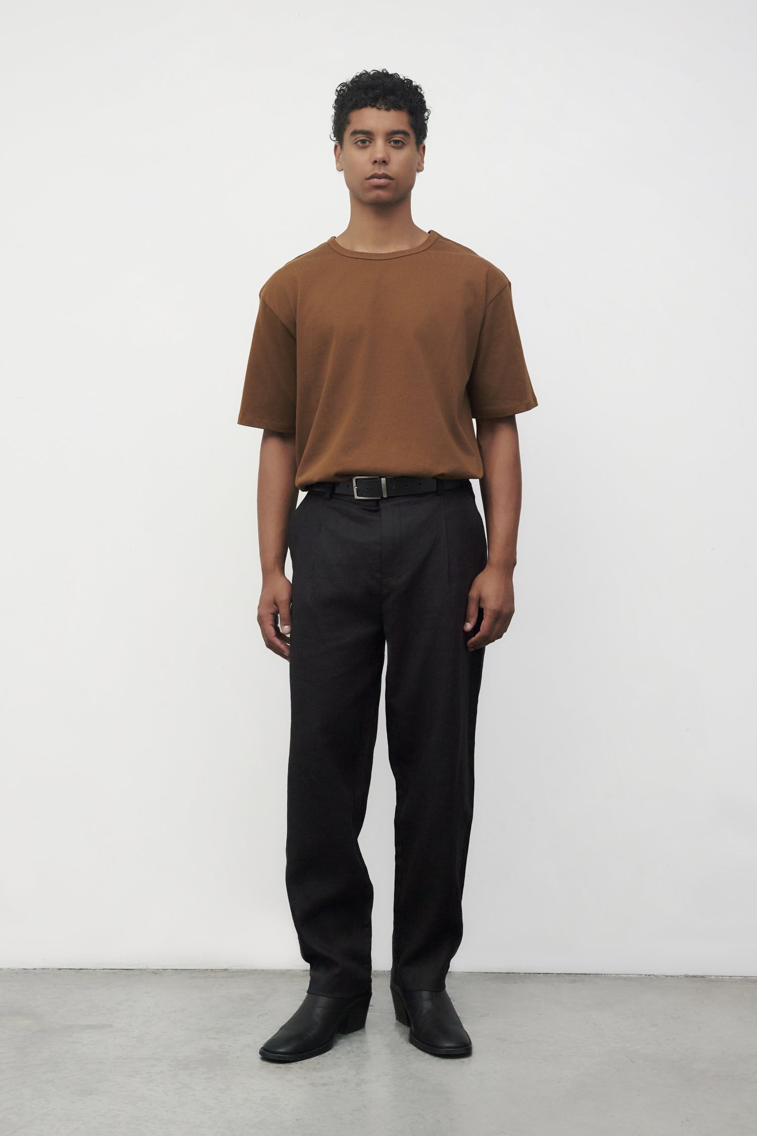 Model wearing brown elias top with black trousers and black boots