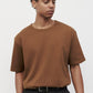 Model wearing brown elias top, close up view