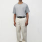 Model wearing heather grey elias top with cream pants and black oxfords