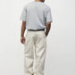 Model wearing heather grey elias top with cream pants and black oxfords, back side