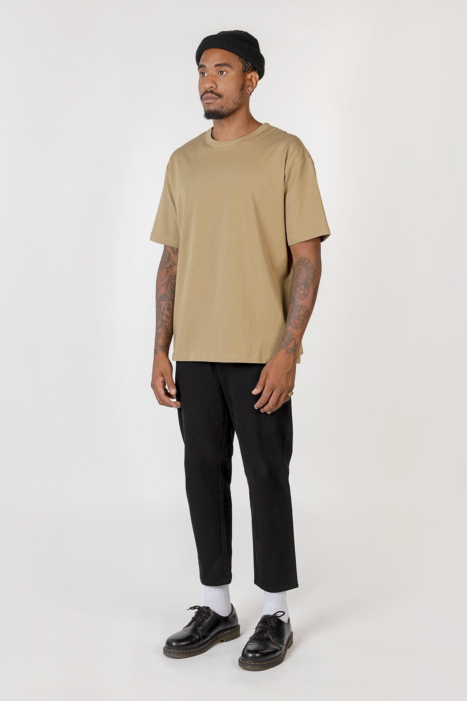 Model wearing black elias top, side view