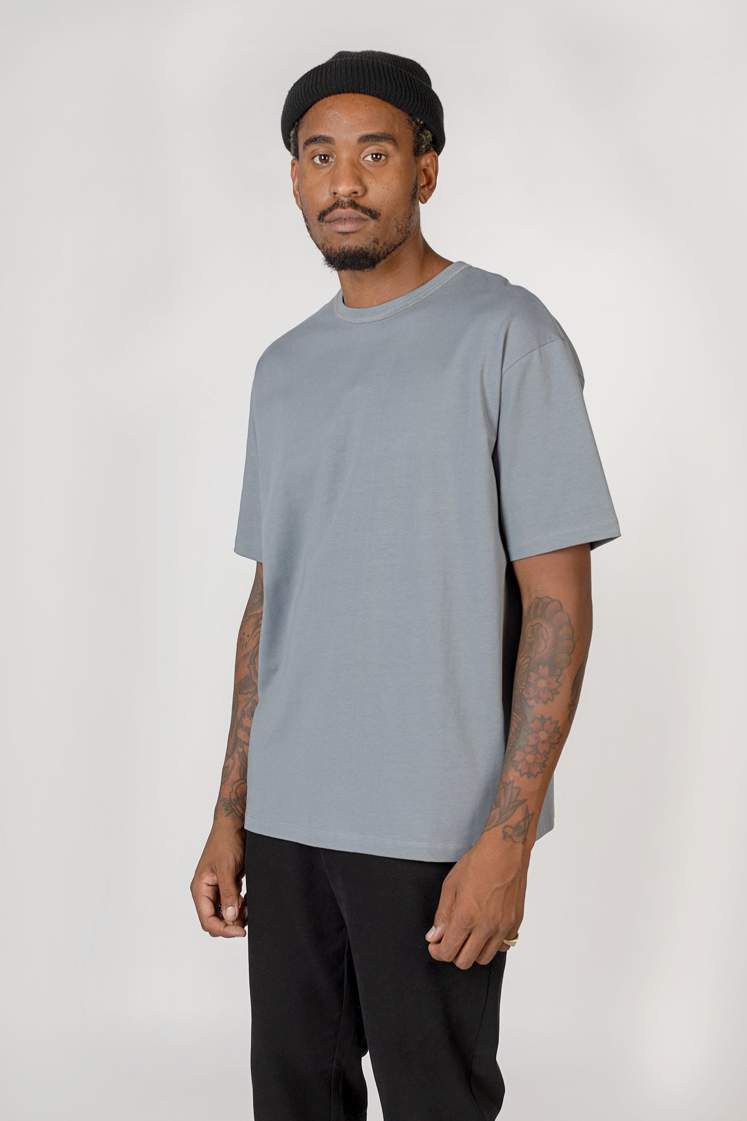 Model wearing slate blue Elias top, close up view