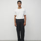 Model wearing white elias top with trousers and black loafers