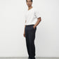 Model wearing white elias top with trousers and black loafers