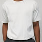 Model wearing white elias top with Grey Wayne Pants
