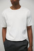 Model wearing white elias top with Grey Wayne Pants